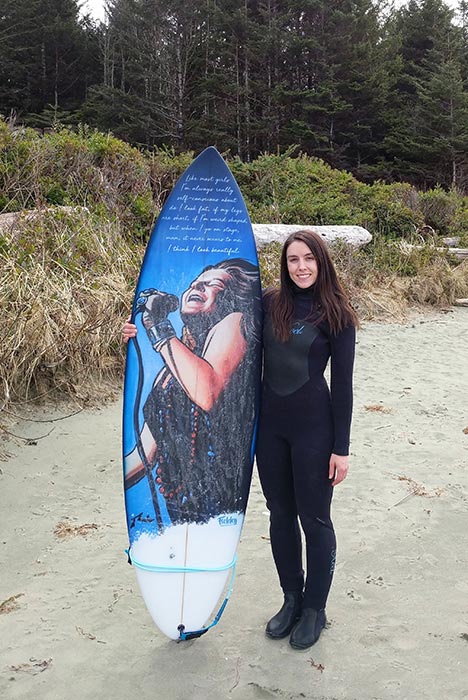 A happy client with their custom surfboard art