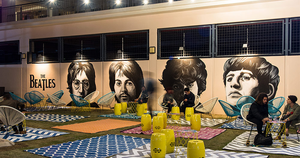 Large-scale portrait street art mural of The Beatles