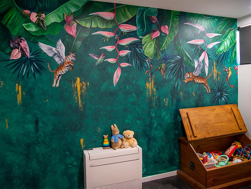 Hand-painted botanical nursery mural in a baby room.