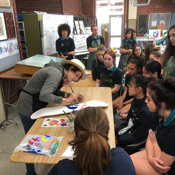 Fieldey doing a skate board painting workshop at Safety Bay Senior High